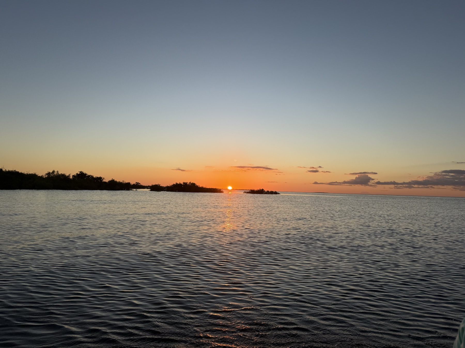 A calm river beach glowing at sunset in the low-water season